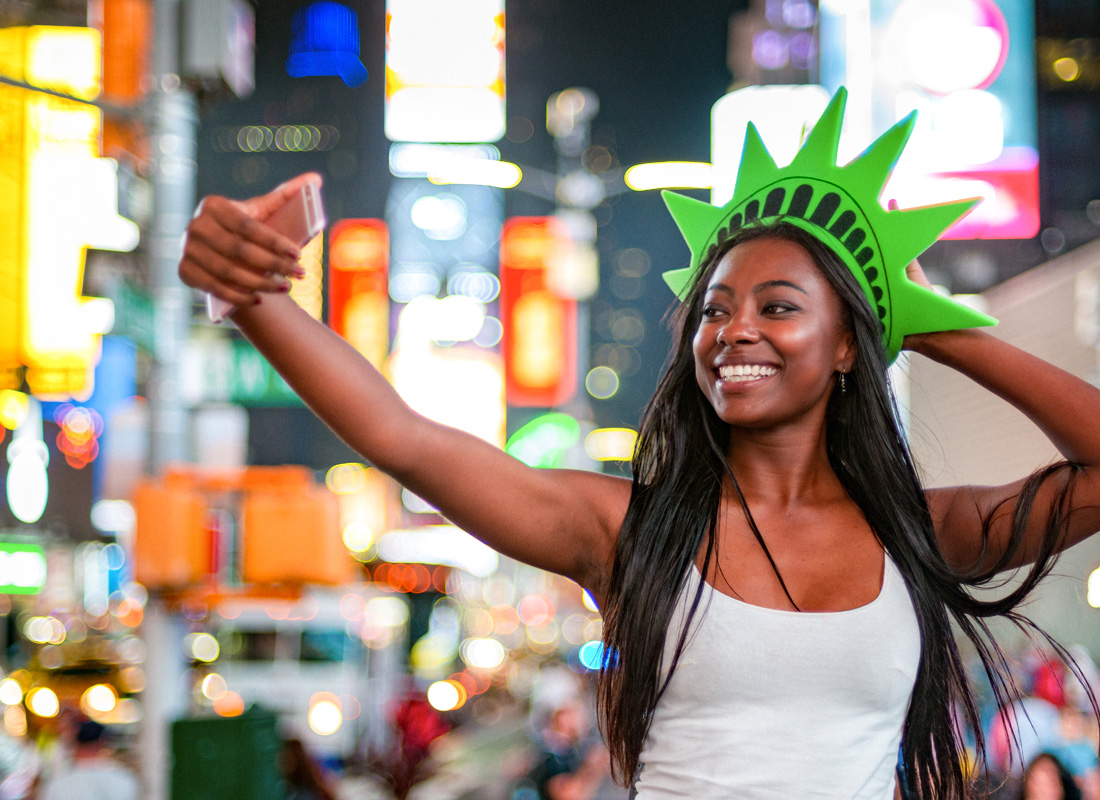 RCI Exchange Plus, Woman taking a selfie at night in a crowded city