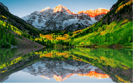 Stunning Maroon Bells reflecting on the water in the early morning hours in the Elk Mountains, just outside of Aspen.