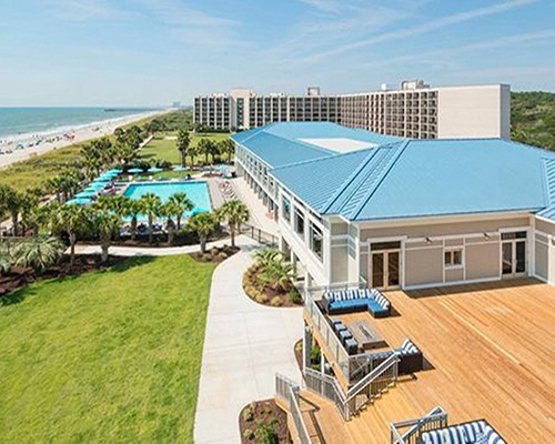 An aerial view of the pool side and beach side of the Doubletree Hilton Myrtle Ocean