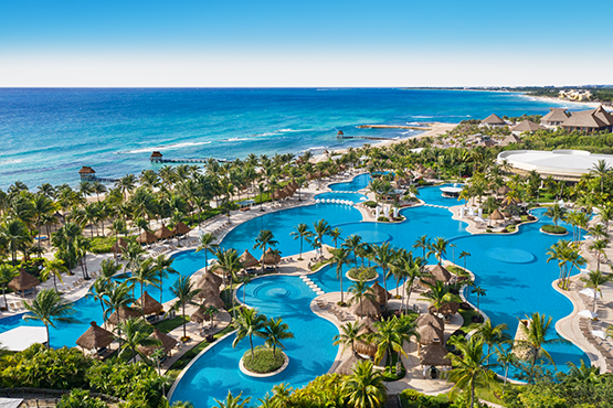 An aerial view of a beachfront resort and its pool area