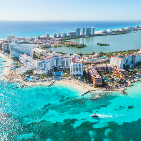 An aerial view of a resort in Cancun surrounded by bright blue waters