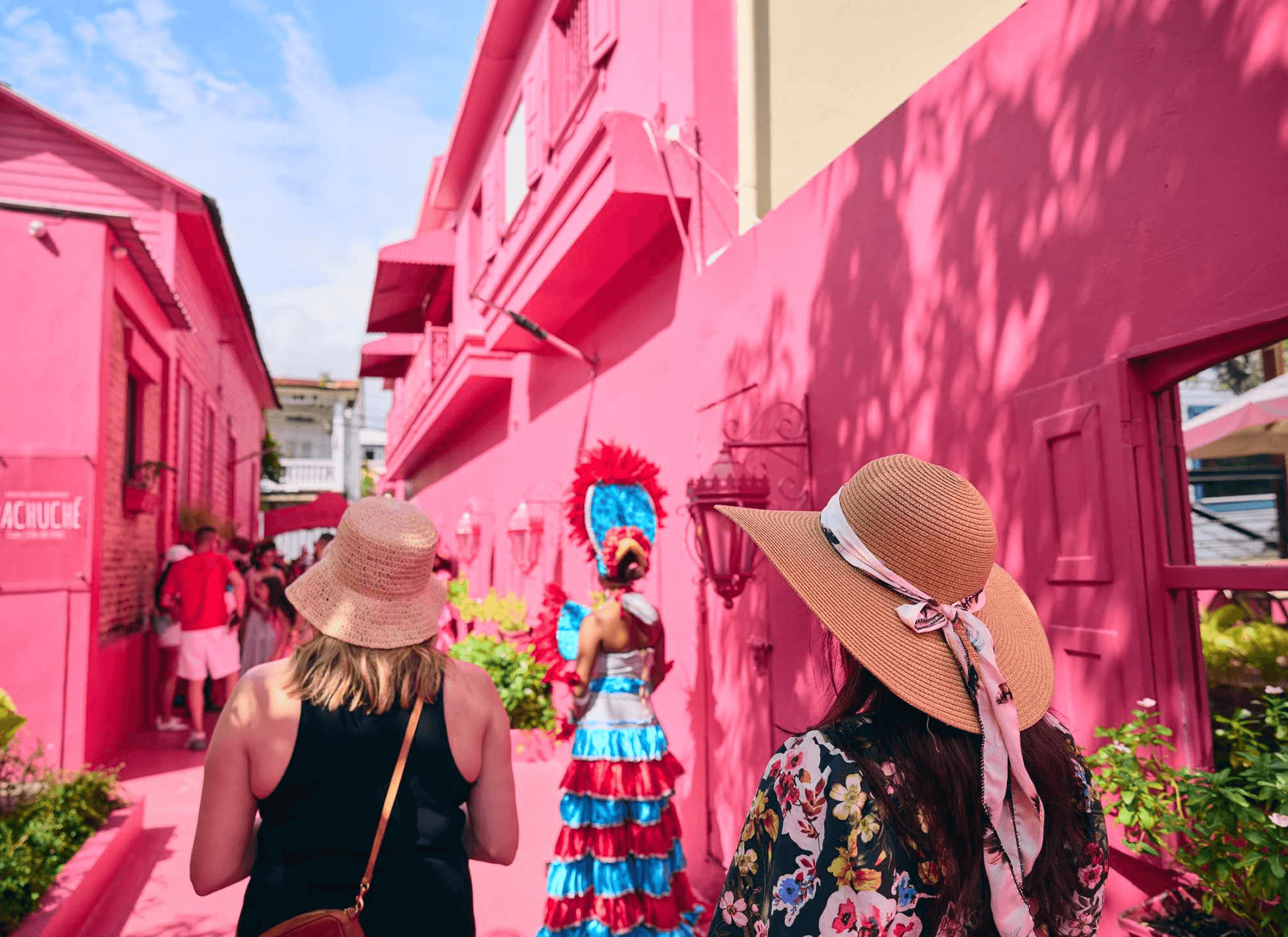 Two women exploring the pink streets of Dominican Republic.