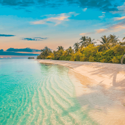 A serene island beach in the afternoon with glistening clear water