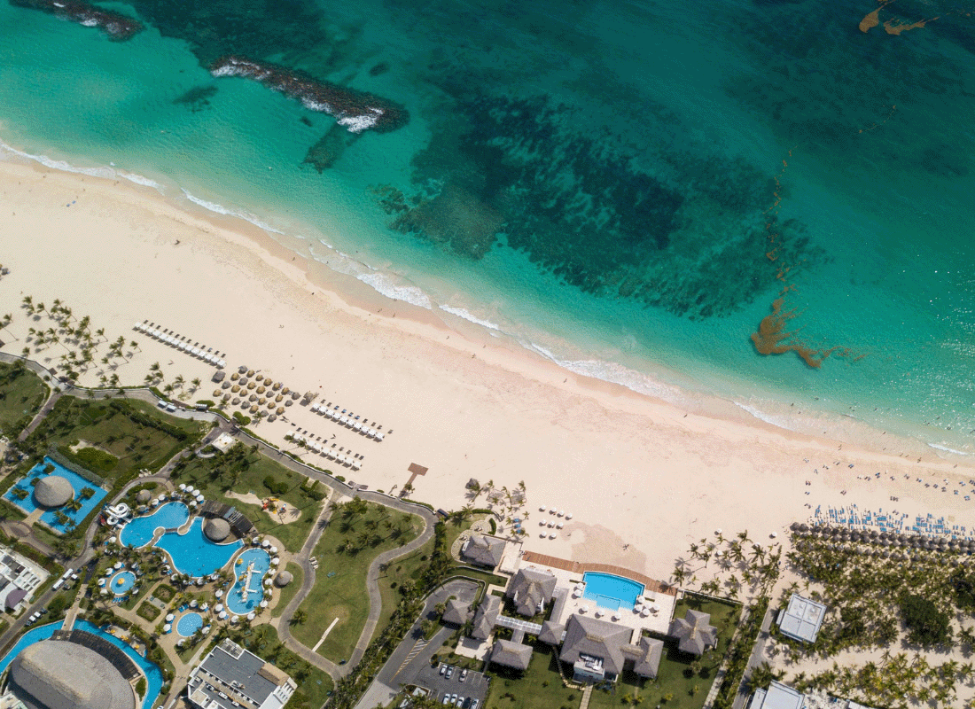 Panoramic aerial perspective of a beach resort area with buildings and amenities.
