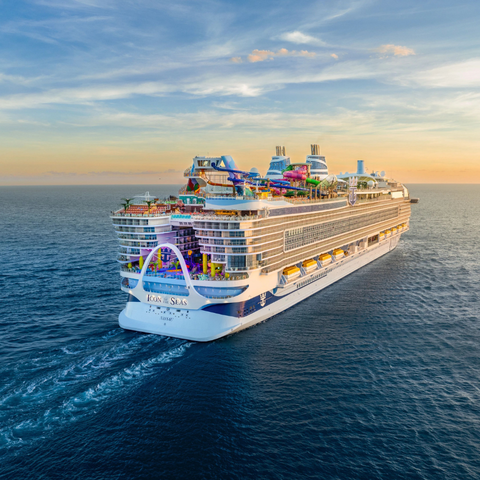 A large cruiseship sailing in the sunset.