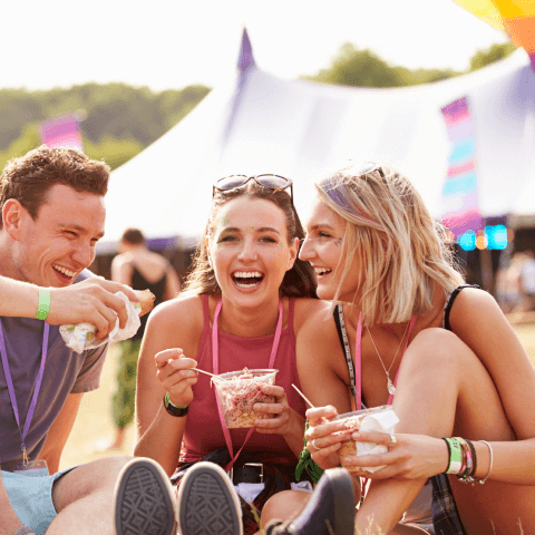 A group of friends enjoying food at a festival.