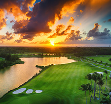 An aerial view of a lush golf course at sunset