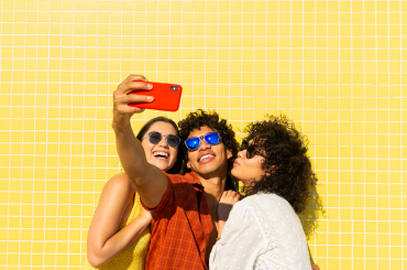 Friends taking selfie with sunglasses