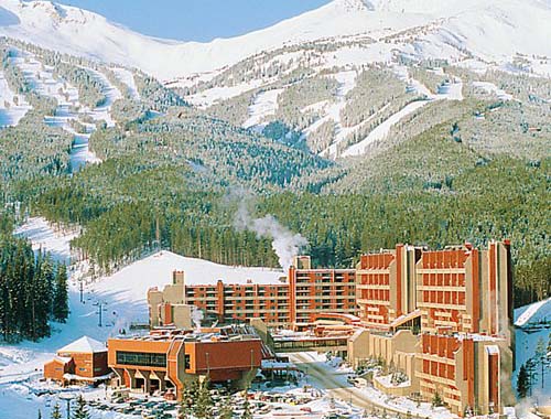 A scenic ski resort with snow-covered slopes and a majestic mountain backdrop.