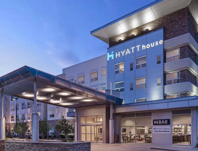 Hyatt House hotel exterior at dusk, showcasing its modern architecture and welcoming entrance.