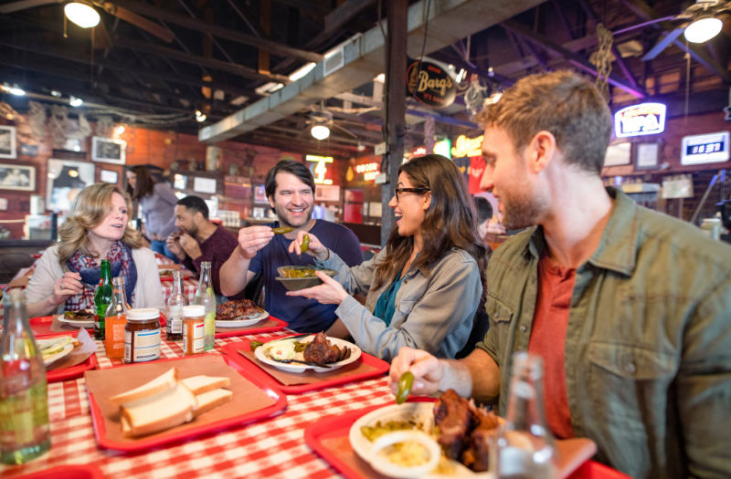 A group of people enjoying a meal together at a restaurant in Austin, Texas.