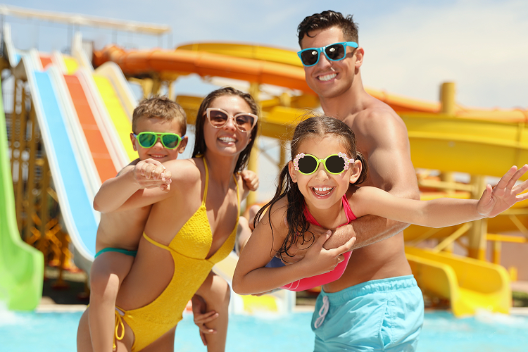 A family of four enjoying a sunny day at the waterpark.