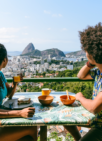 Two people seated at a table enjoying a city view in Brazil.
