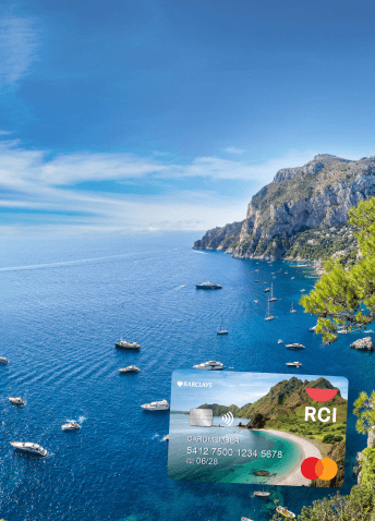 The RCI Barclays credit card over a scenic view of a shore lined with small white boats.