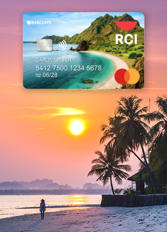 A Barclays RCI credit card floating above a woman walking on the beach at dusk