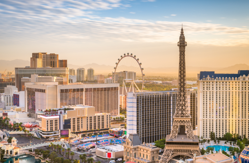 Aerial view of the Las Vegas Strip skyline with the Eiffel Tower Restaurant in the foreground.