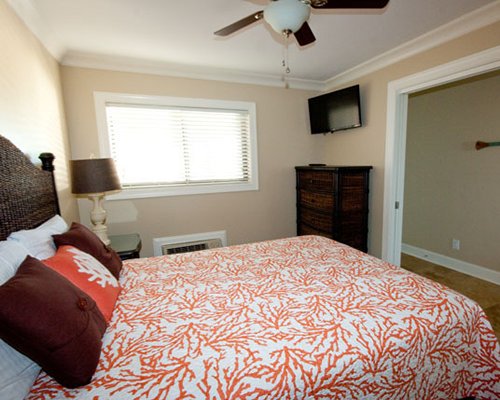 A compact bedroom with a queen bed.