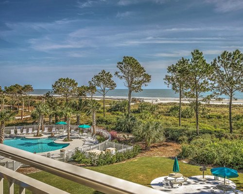 Balcony view of the outdoor pool and beach.