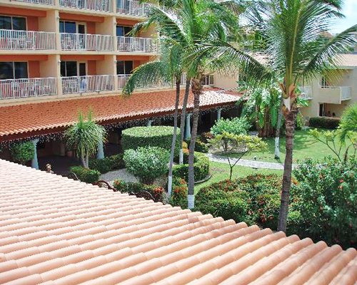 Multiple units with private balconies and a garden view.