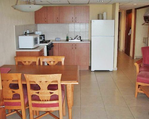 A furnished kitchen with wooden dining.