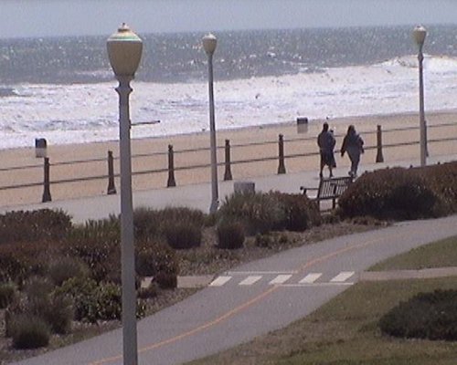 A fenced boardwalk with beach access.