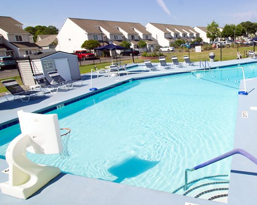 Outdoor swimming pool with chaise lounge chairs.