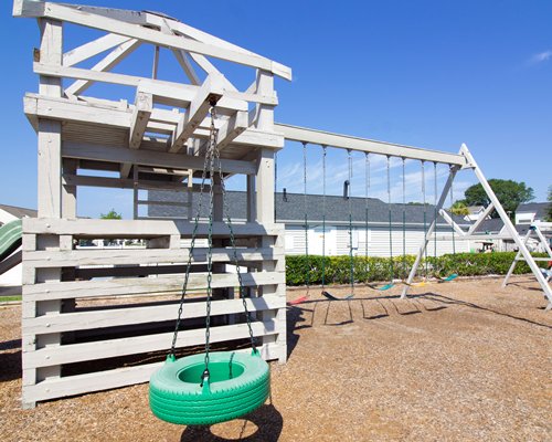 An outdoor tennis court alongside resort units.