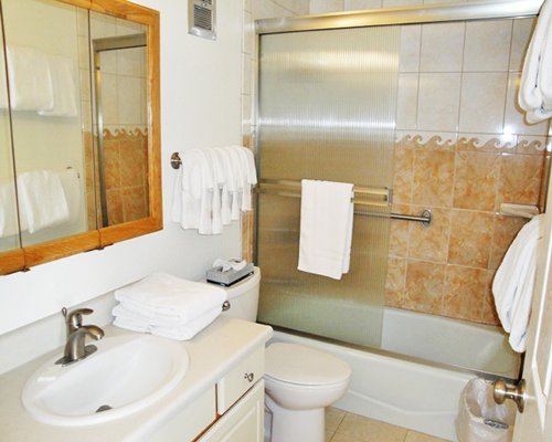 A bathroom with shower, bathtub and vanity.