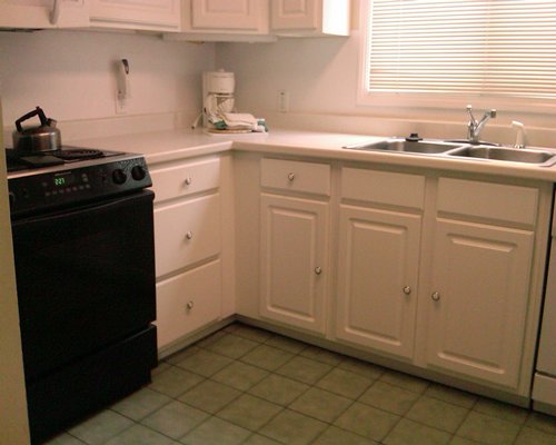 Kitchen with stove and large double bowl sink.