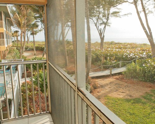 A balcony view of a scenic landscape alongside the ocean.