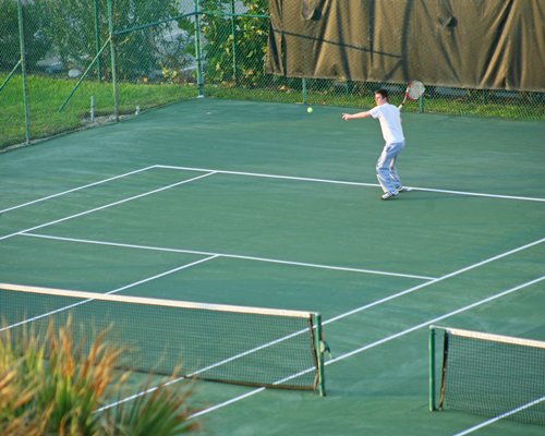 A person playing in a tennis court.