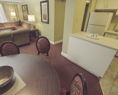 A well furnished bedroom with king bed and outside view.