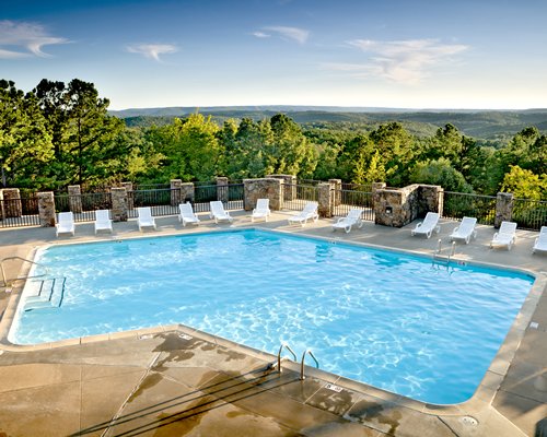Scenic outdoor swimming pool with chaise lounge chairs.