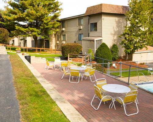 Picnic area with patio chairs and outdoor swimming pool.