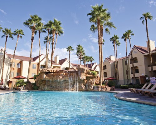 An outdoor swimming pool alongside resort units.