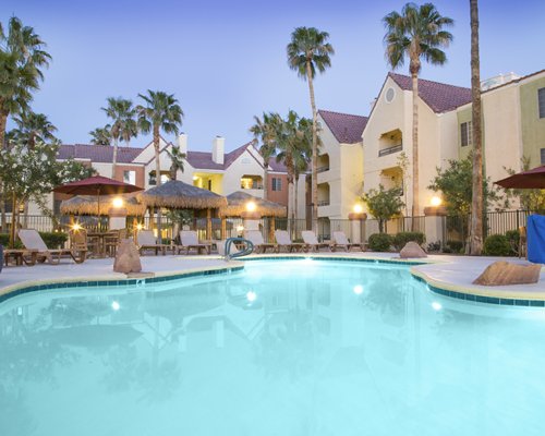 An outdoor swimming pool alongside resort units.