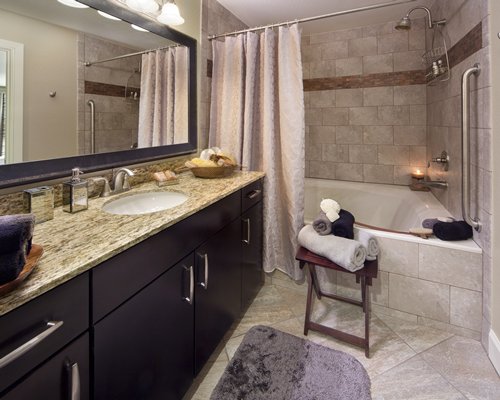 A bathroom with a shower and bathtub.