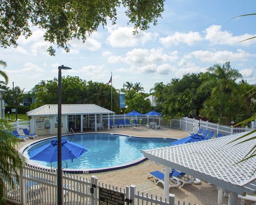 Scenic view of multiple apartments at Oyster Bay with chaise lounge chairs.