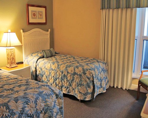 A well furnished bedroom with two double beds.