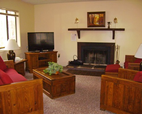 An interior view of living area with fireplace television and window view.