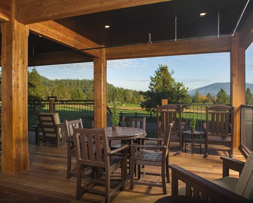 Dining area with a view of golf course trees and mountain.