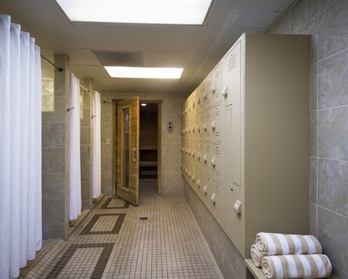 A bathroom with a combination of dress lockers and showers.