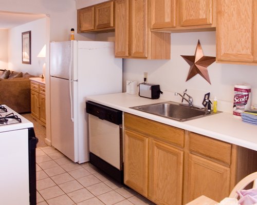 A well equipped kitchen with a view of living room.