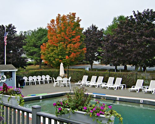 A scenic outdoor swimming pool with chaise lounge chairs.