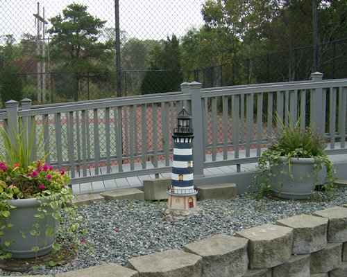 A wooden pathway alongside outdoor play area.