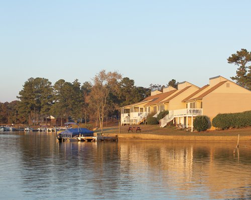 Lake view of Fairfield Plantation resort units surrounded by wooded area.