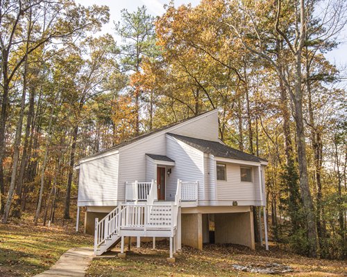 Front view of a unit surrounded by a wooded area.