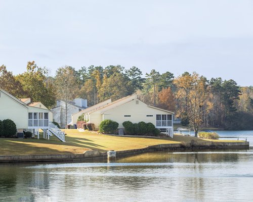 A lake view of Fairfield Plantation resort units surrounded by wooded area.
