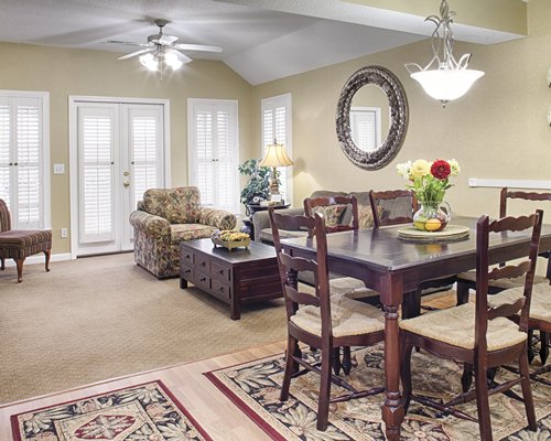 A living room with queen pull out sofa and a wooden dining table.