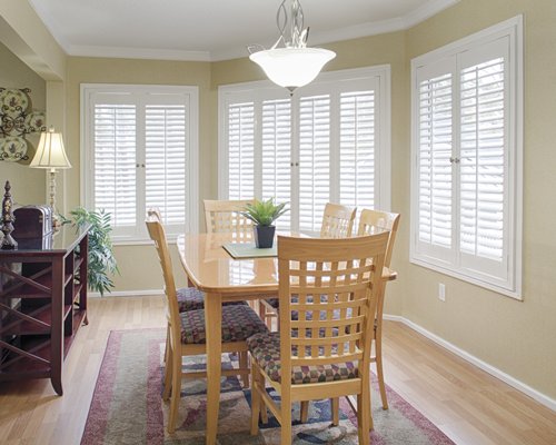 A well furnished dining area with a wooden table.